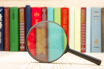 Hardback books and magnifying glass