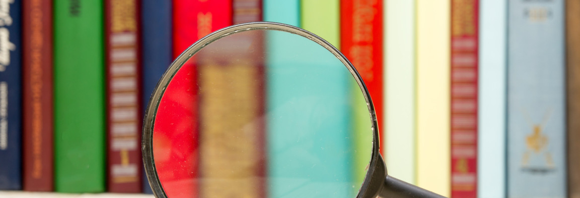 Hardback books and magnifying glass
