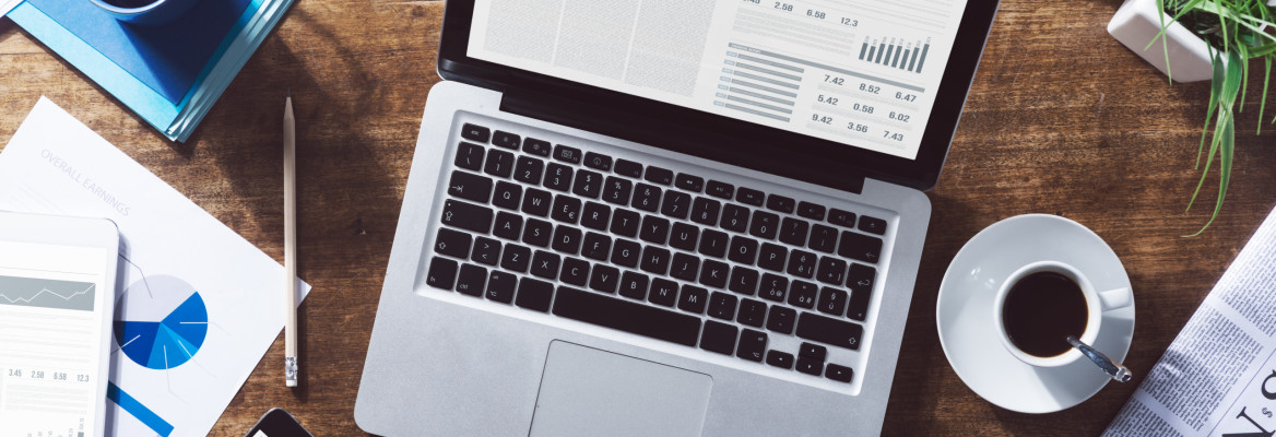 Life science industry news online on a laptop with coffee and stationery